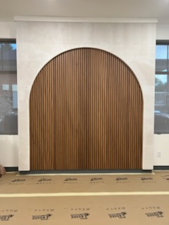 Custom arched wood slat feature wall built by Porter Carpentry in Atlanta